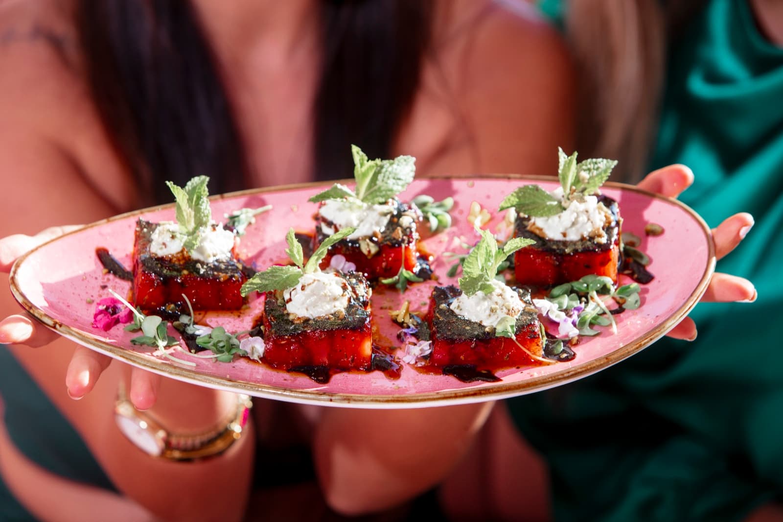 Seared watermelon with whipped feta on a pink platter